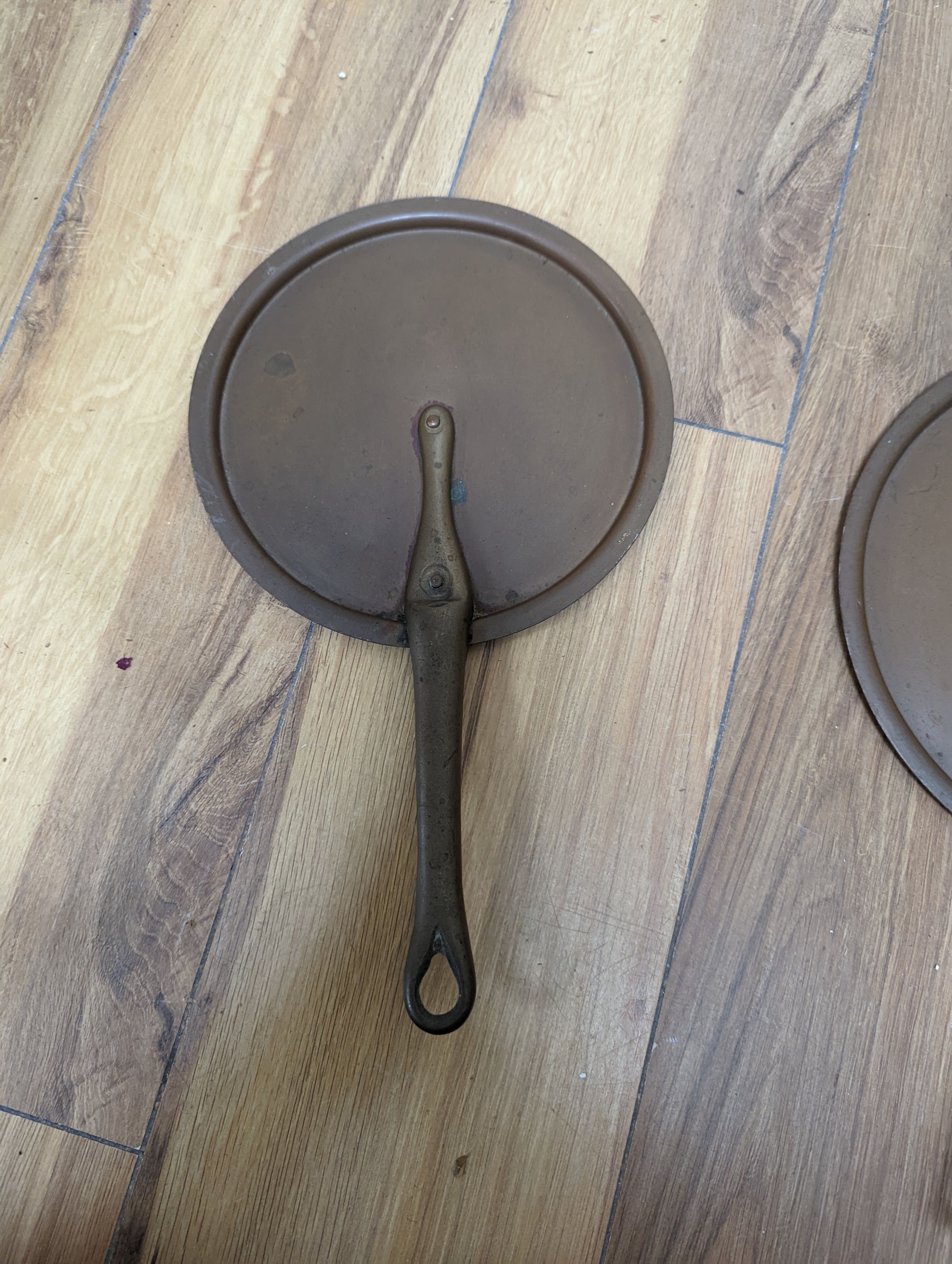 A group of three Jaeggi & Sons copper saucepans